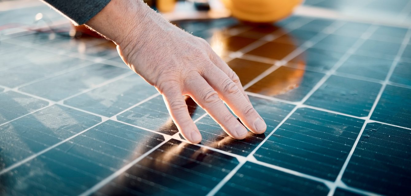 Hands, engineer and solar panel in construction for renewable en
