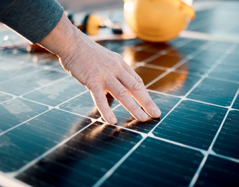 Hands, engineer and solar panel in construction for renewable en
